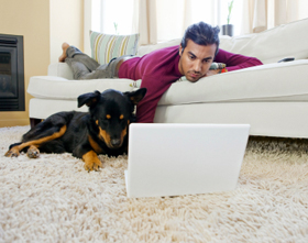 Man on a computer with his dog