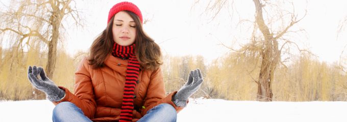 woman doing yoga in the snow